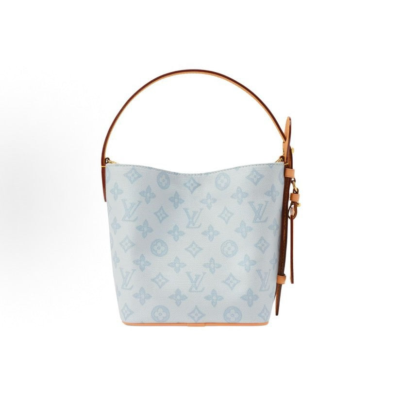 2026 All In BB Bucket Bag in Messenger Blue, crafted from coated canvas with natural cowhide trim M27529